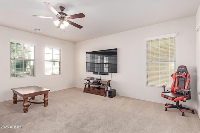 miscellaneous room with visible vents, a ceiling fan, and carpet flooring