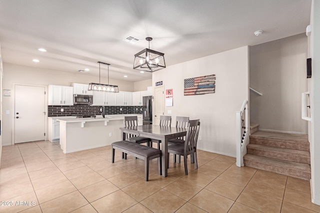 dining area featuring light tile patterned floors, visible vents, recessed lighting, and stairs