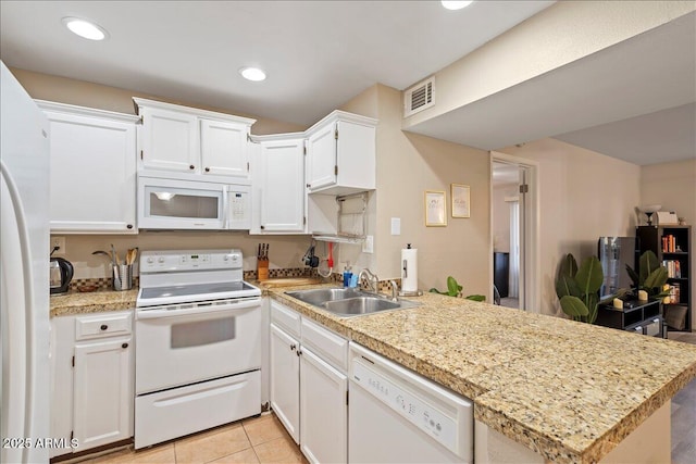 kitchen featuring a peninsula, a sink, white cabinets, white appliances, and light countertops