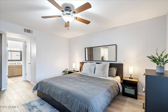 bedroom featuring baseboards, light wood finished floors, visible vents, and a ceiling fan