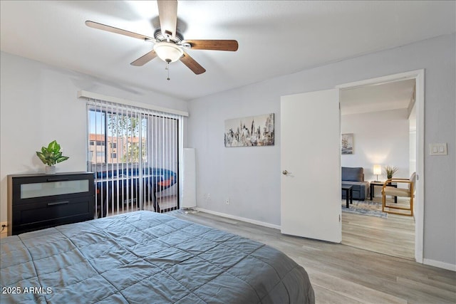 bedroom with baseboards, a ceiling fan, and wood finished floors