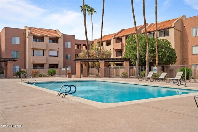 pool featuring a patio area and fence