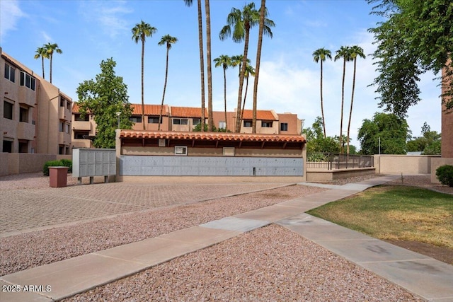 view of property's community featuring fence and mail area