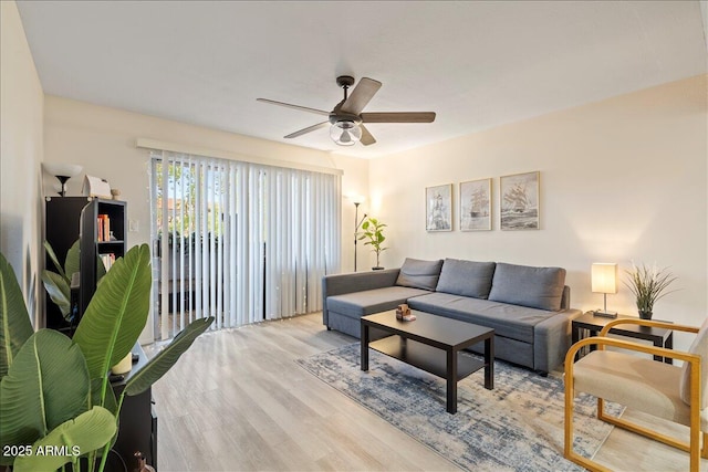 living area featuring wood finished floors and a ceiling fan