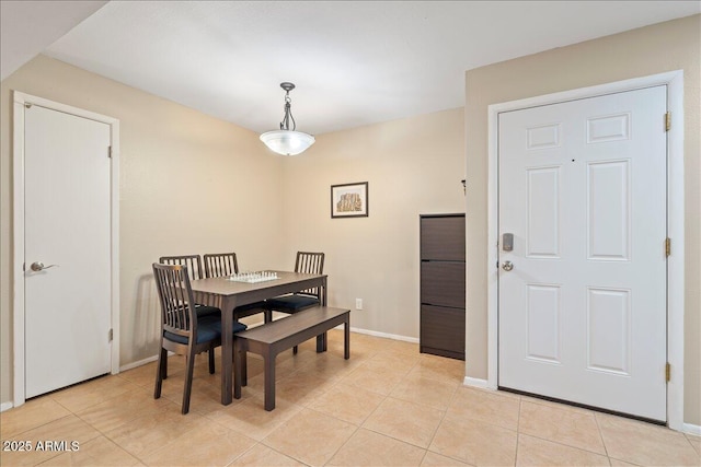 dining room with baseboards and light tile patterned floors