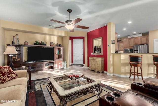 living room with ceiling fan and light tile patterned flooring