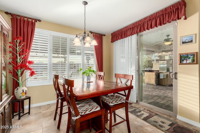 dining area featuring ceiling fan with notable chandelier and light tile patterned floors