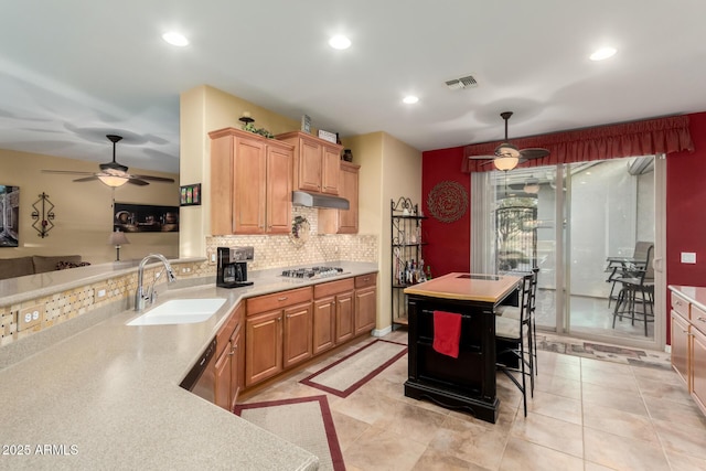 kitchen featuring appliances with stainless steel finishes, sink, decorative light fixtures, tasteful backsplash, and light tile patterned floors