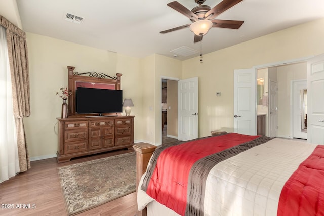 bedroom featuring ceiling fan, ensuite bathroom, and light hardwood / wood-style flooring