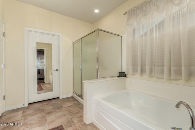 bathroom with separate shower and tub and tile patterned floors