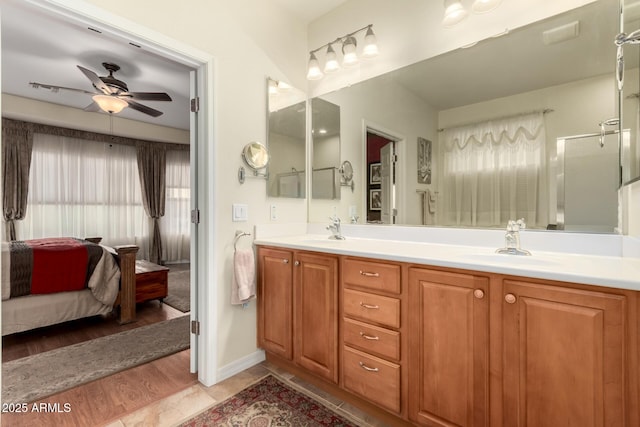 bathroom featuring ceiling fan, walk in shower, and vanity