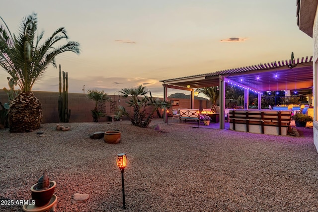 yard at dusk with a pool and a patio