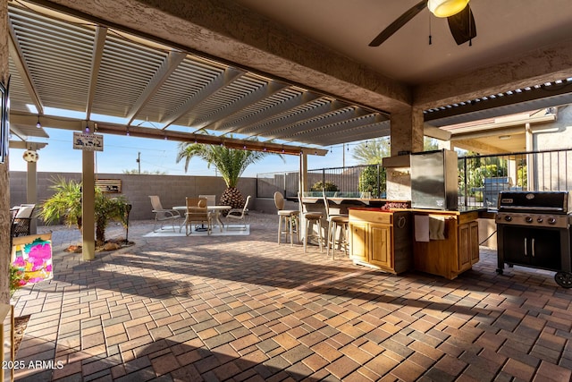 view of patio / terrace with a bar, grilling area, a pergola, and ceiling fan