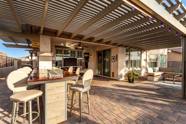 view of patio / terrace featuring outdoor lounge area, ceiling fan, a pergola, and exterior bar