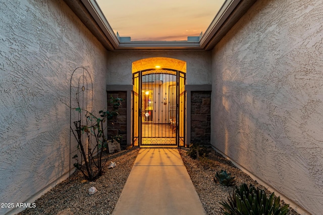 view of exterior entry at dusk