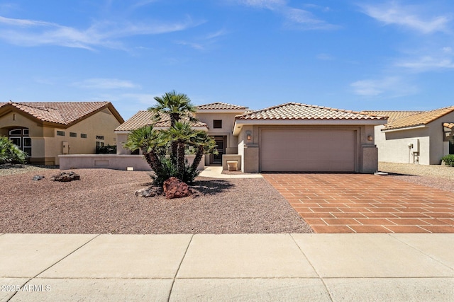 22622 N Mazatlan Dr, Sun City West, AZ 85375 - mediterranean / spanish home with an attached garage, decorative driveway, stucco siding, and a tiled roof