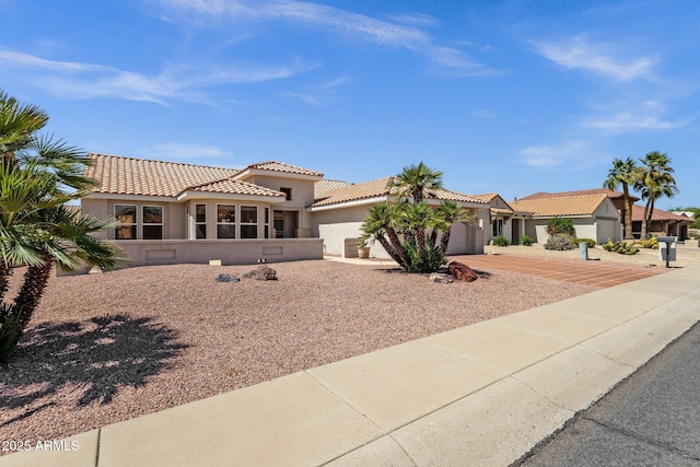 22622 N Mazatlan Dr, Sun City West, AZ 85375 - mediterranean / spanish-style house with concrete driveway, a garage, a tile roof, and stucco siding