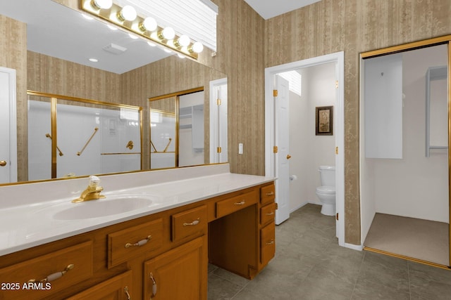 22622 N Mazatlan Dr, Sun City West, AZ 85375 - full bathroom with a stall shower, vanity, baseboards, toilet, and wallpapered walls