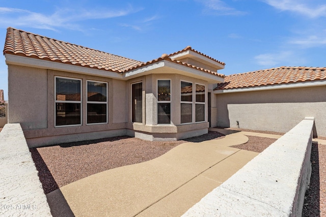 22622 N Mazatlan Dr, Sun City West, AZ 85375 - back of house with a patio, stucco siding, and a tile roof