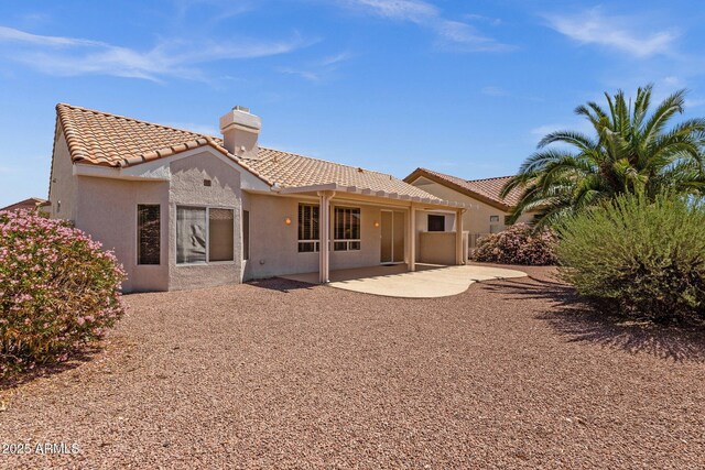 22622 N Mazatlan Dr, Sun City West, AZ 85375 - rear view of house with a chimney, stucco siding, a patio area, and a tiled roof
