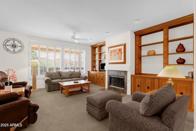 22622 N Mazatlan Dr, Sun City West, AZ 85375 - carpeted living area featuring a tiled fireplace, a ceiling fan, and built in features