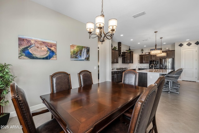 tiled dining space featuring a chandelier