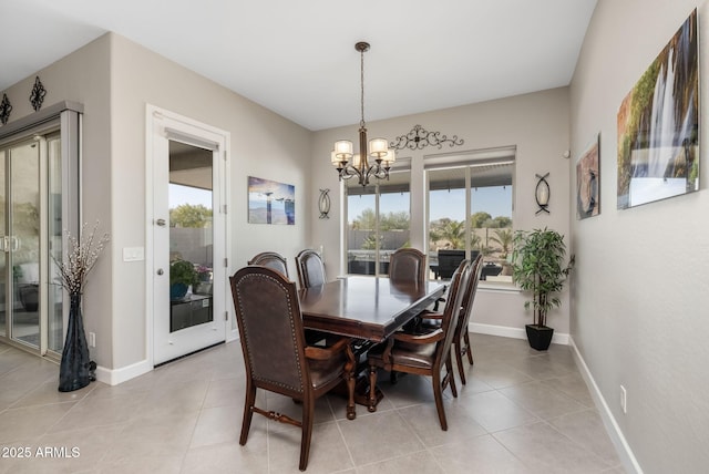 dining room with light tile patterned floors and a notable chandelier