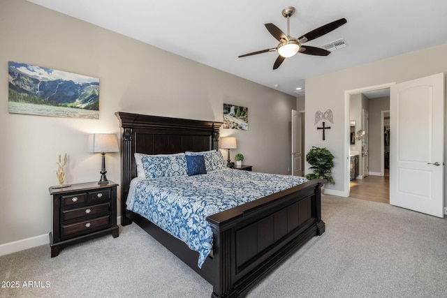 carpeted bedroom with connected bathroom and ceiling fan