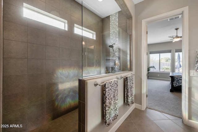 bathroom with walk in shower, ceiling fan, and tile patterned floors