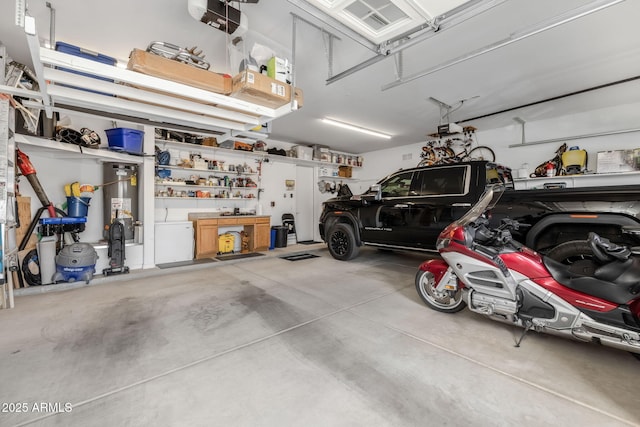 garage with a garage door opener and a workshop area