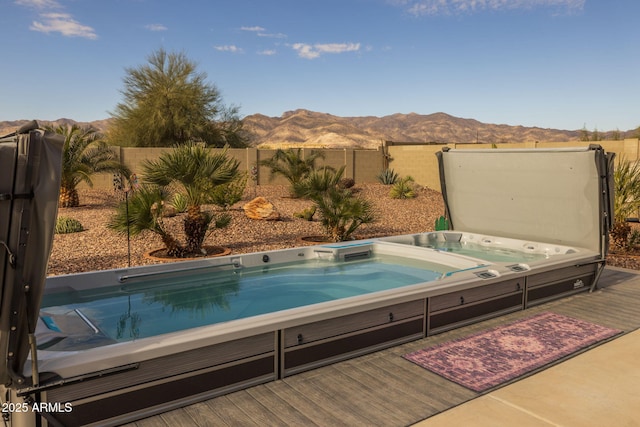 view of pool featuring a deck with mountain view