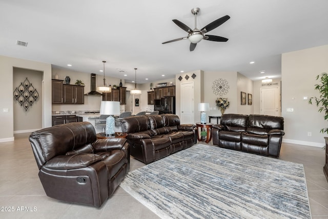 tiled living room with ceiling fan