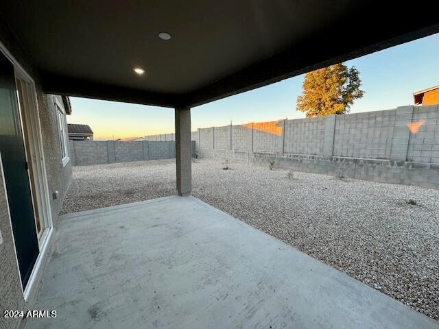 view of patio terrace at dusk