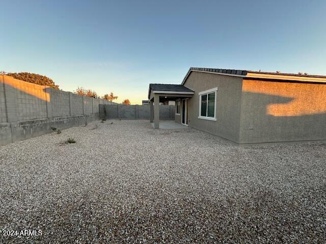 yard at dusk featuring a patio