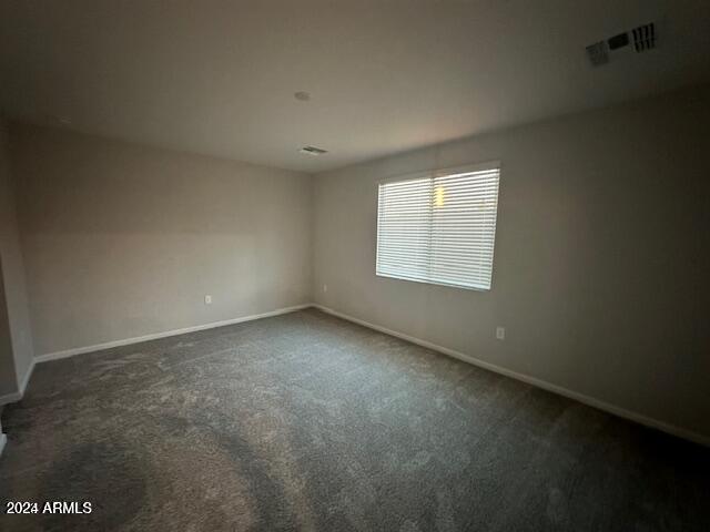 empty room with dark carpet