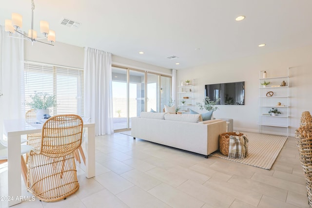 tiled living room with built in shelves and an inviting chandelier