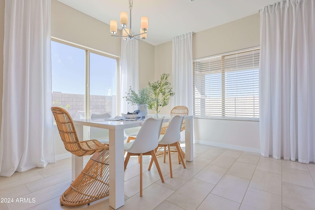 dining space with plenty of natural light, light tile patterned floors, and a chandelier