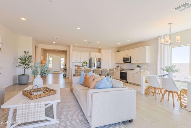 living room featuring a notable chandelier