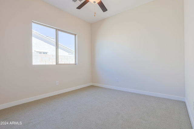 spare room with ceiling fan and carpet