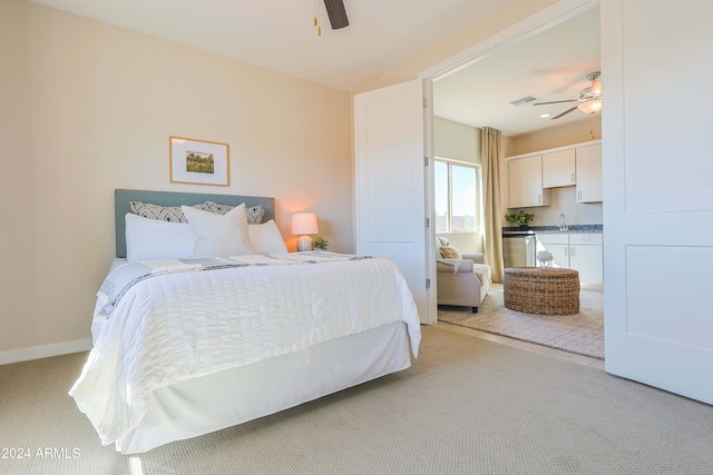 bedroom featuring ceiling fan and light carpet