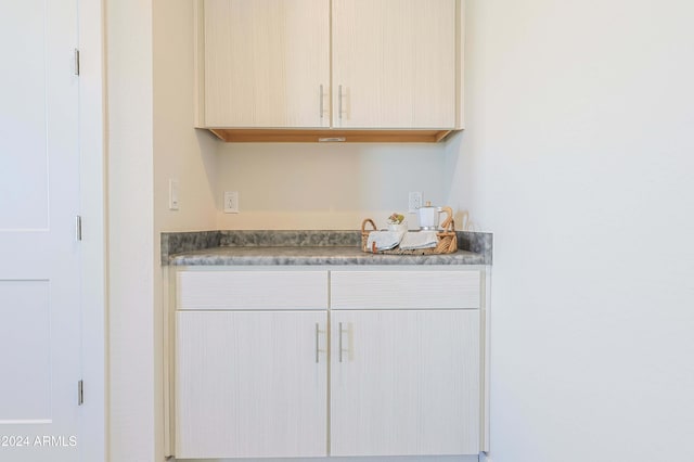 bar with light brown cabinetry