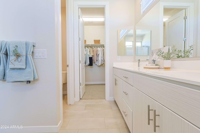 bathroom featuring tile patterned flooring, vanity, and toilet