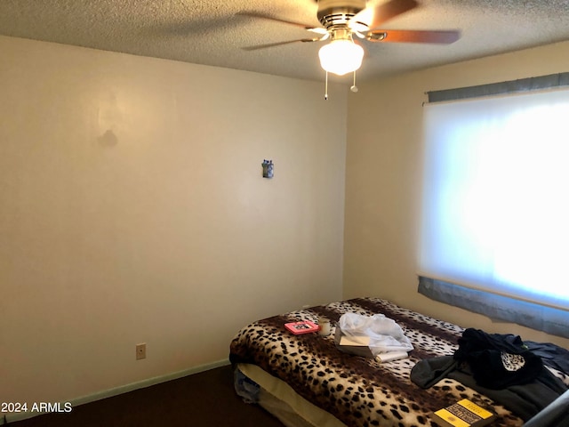 bedroom featuring a textured ceiling and ceiling fan