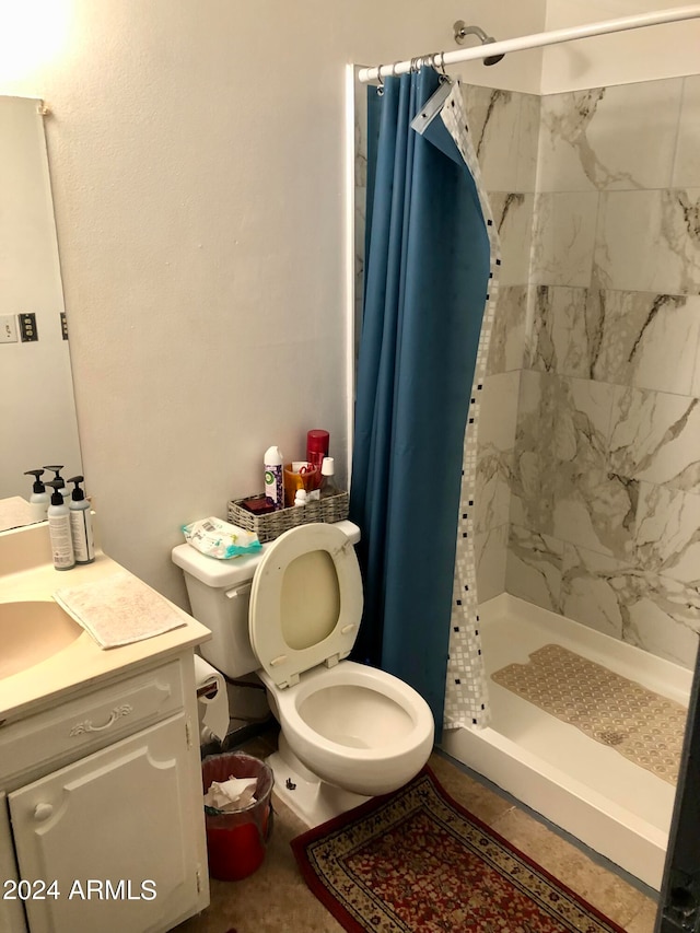 bathroom with curtained shower, tile patterned floors, toilet, and vanity