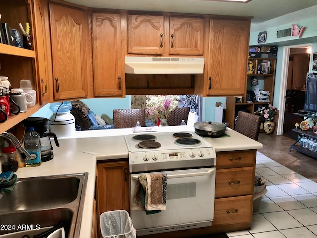 kitchen featuring light tile patterned flooring, sink, and electric stove