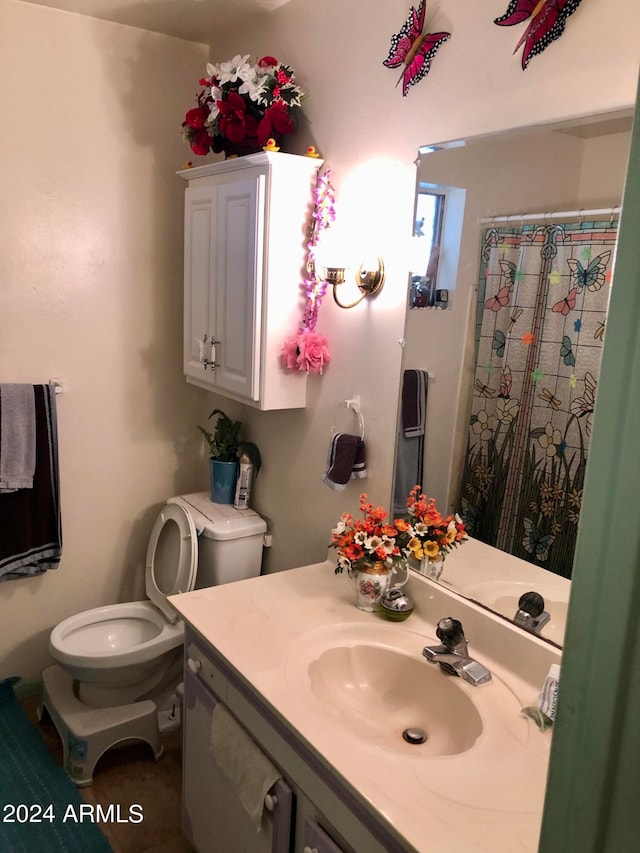 bathroom featuring toilet and vanity