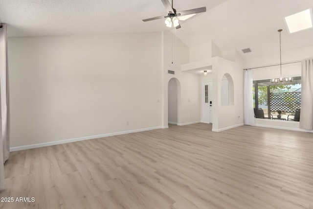 12529 N 83rd Ln, Peoria, AZ 85381 - unfurnished living room with a chandelier, light wood finished floors, baseboards, and high vaulted ceiling