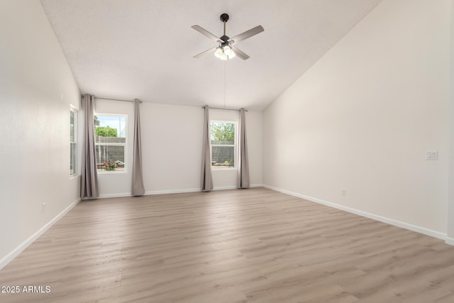 12529 N 83rd Ln, Peoria, AZ 85381 - spare room with a ceiling fan, plenty of natural light, light wood-type flooring, lofted ceiling, and baseboards