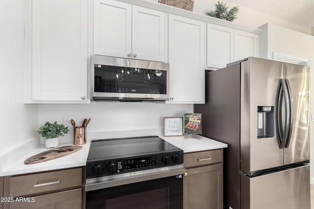 12529 N 83rd Ln, Peoria, AZ 85381 - kitchen featuring appliances with stainless steel finishes, light countertops, and white cabinets