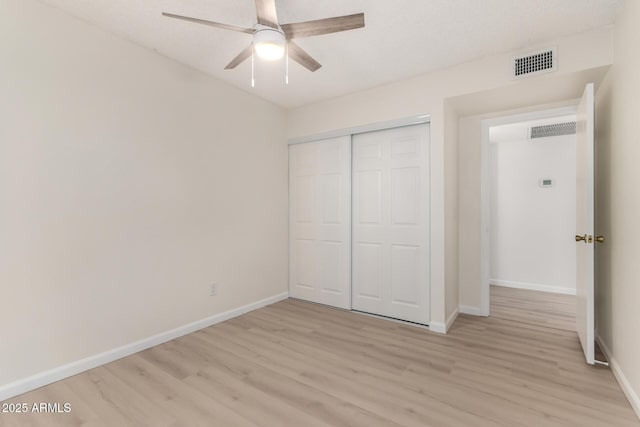 12529 N 83rd Ln, Peoria, AZ 85381 - unfurnished bedroom featuring light wood finished floors, baseboards, a closet, and a ceiling fan